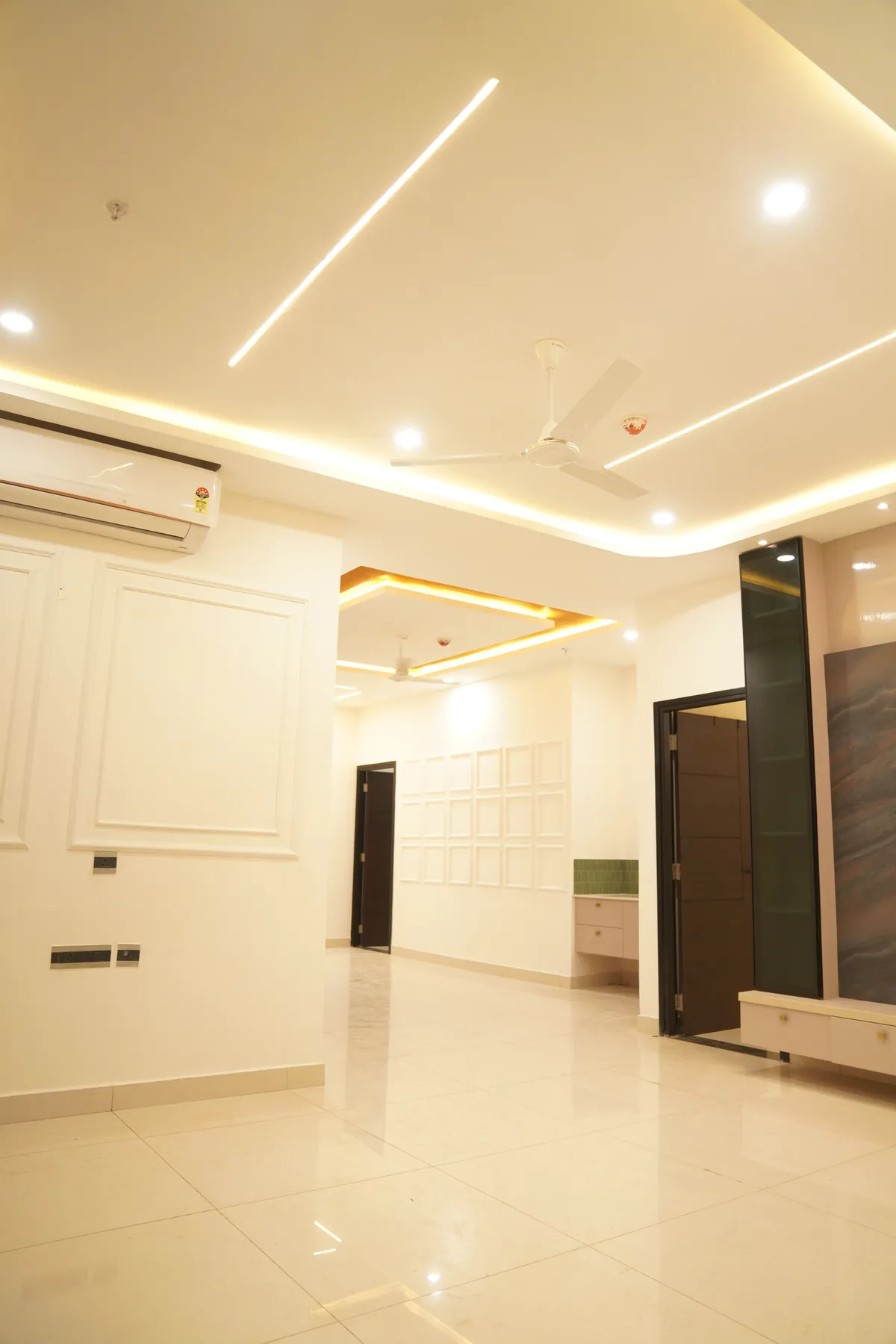 Finished apartment hall with cove-lit ceiling, box-moulded walls and polished floor