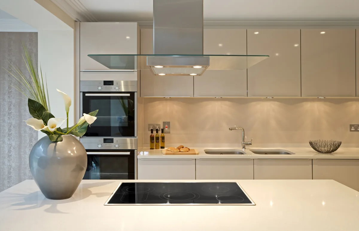 Cream kitchen with built-in ovens and an island hob